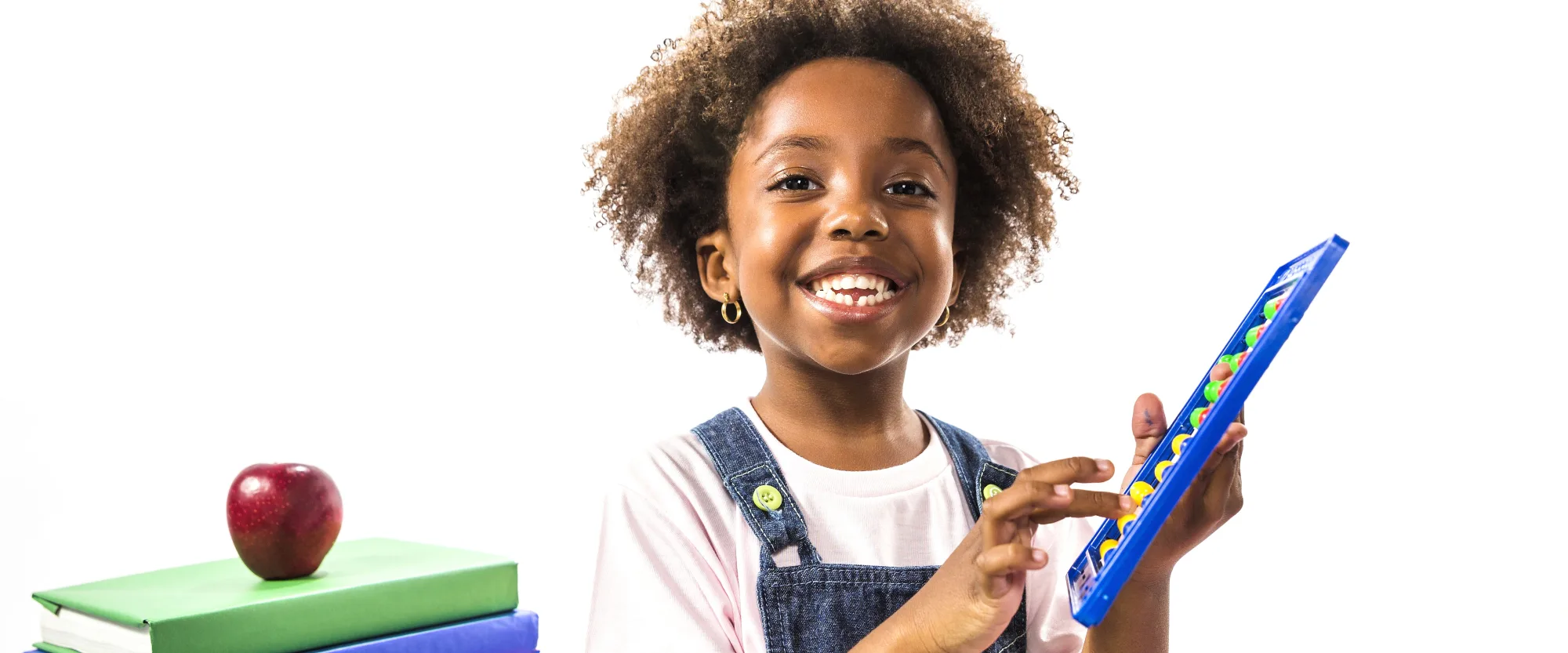 Smiling pupil playing with a colourful abacus beside school books